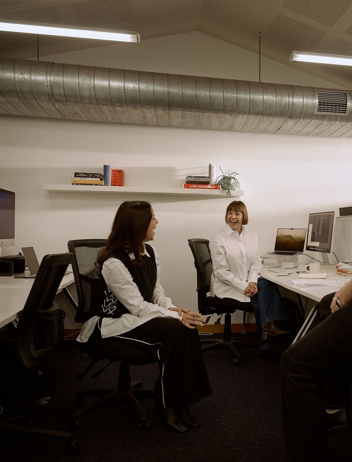 The design team at Fuller talking at their desks