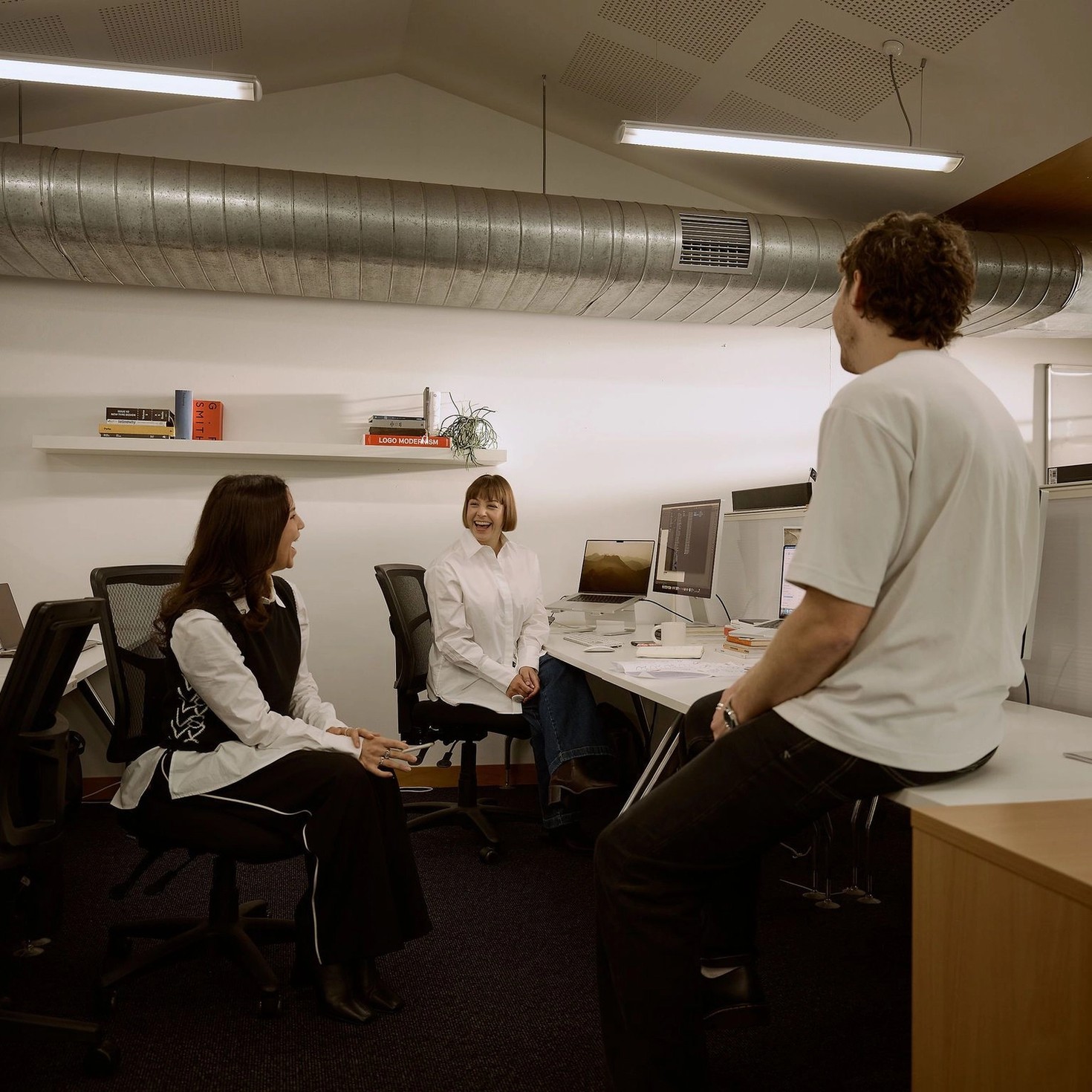 The design team at Fuller talking at their desks