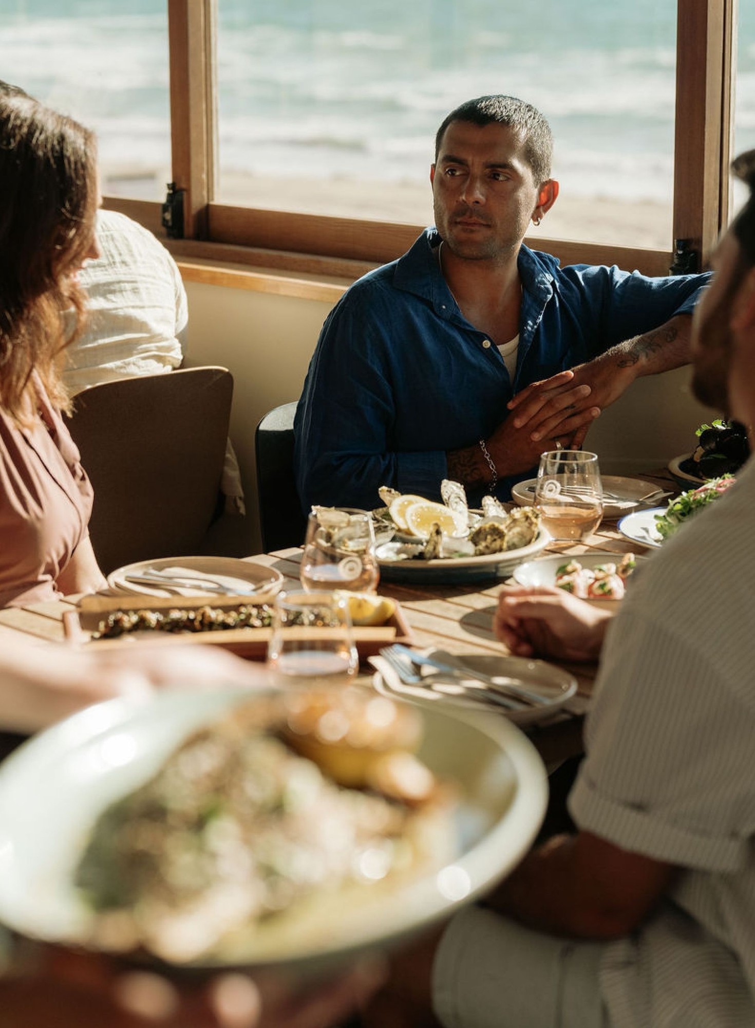 People dining at a restaurant by the beach