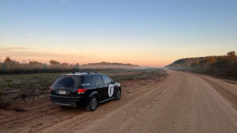 Branded vehicle on a dirt road at sunset during the Kangaroo Island campaign shoot.
