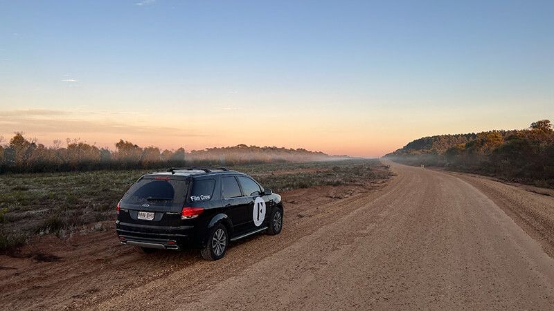 Branded vehicle on a dirt road at sunset during the Kangaroo Island campaign shoot.