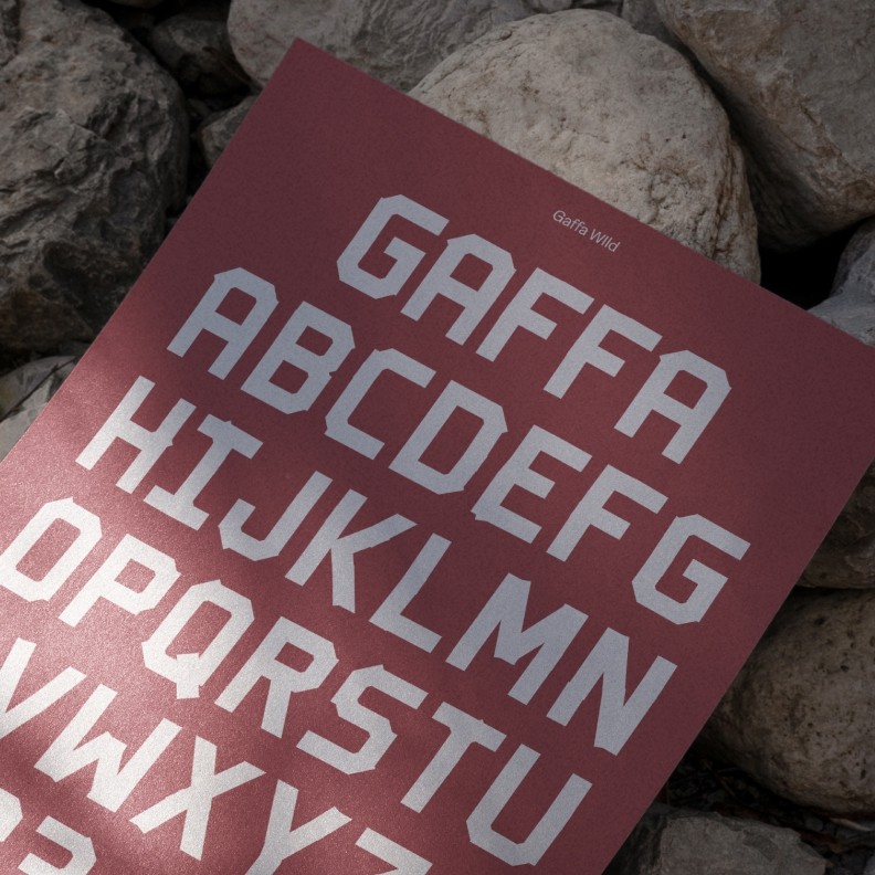 eyre custom typography shown on a flyer sitting on rocks