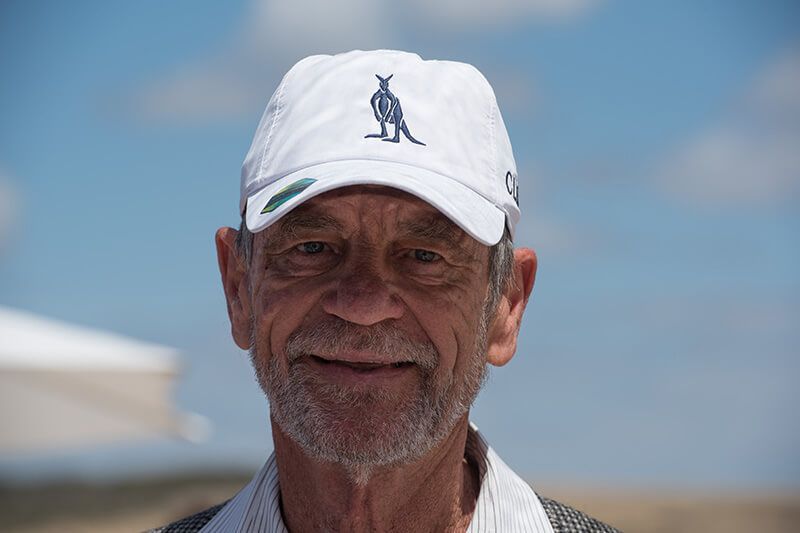 Guest wearing a white cap embroidered with The Cliffs kangaroo emblem.