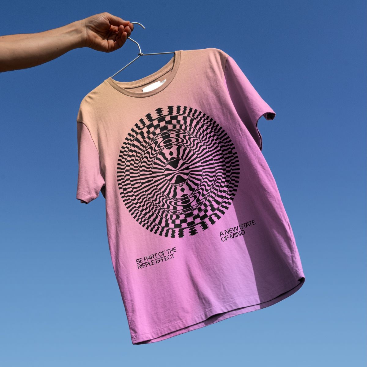 Examples of a tshirt being held up with the new state of mind brand