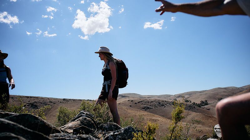 talent standing on a rock wearing an akubra hat