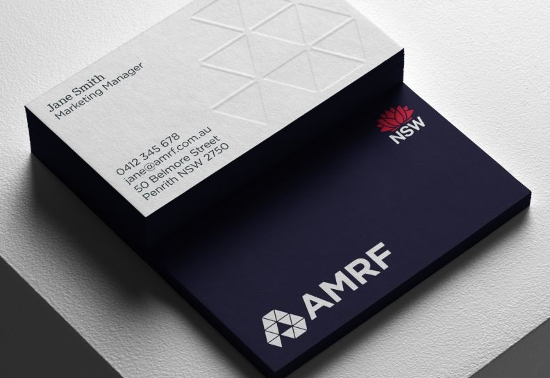 AMRF business card design featuring the navy and white brand identity.