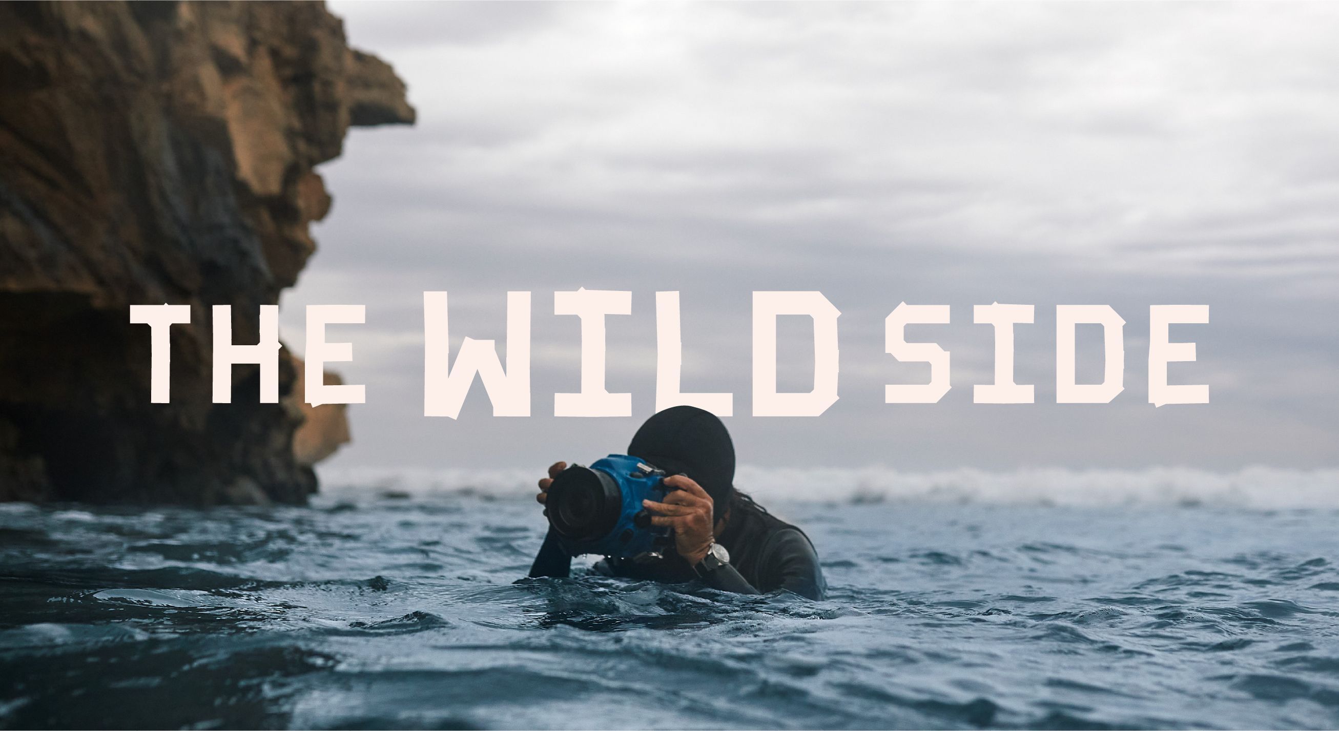 A man filming underwater with the wild side identity