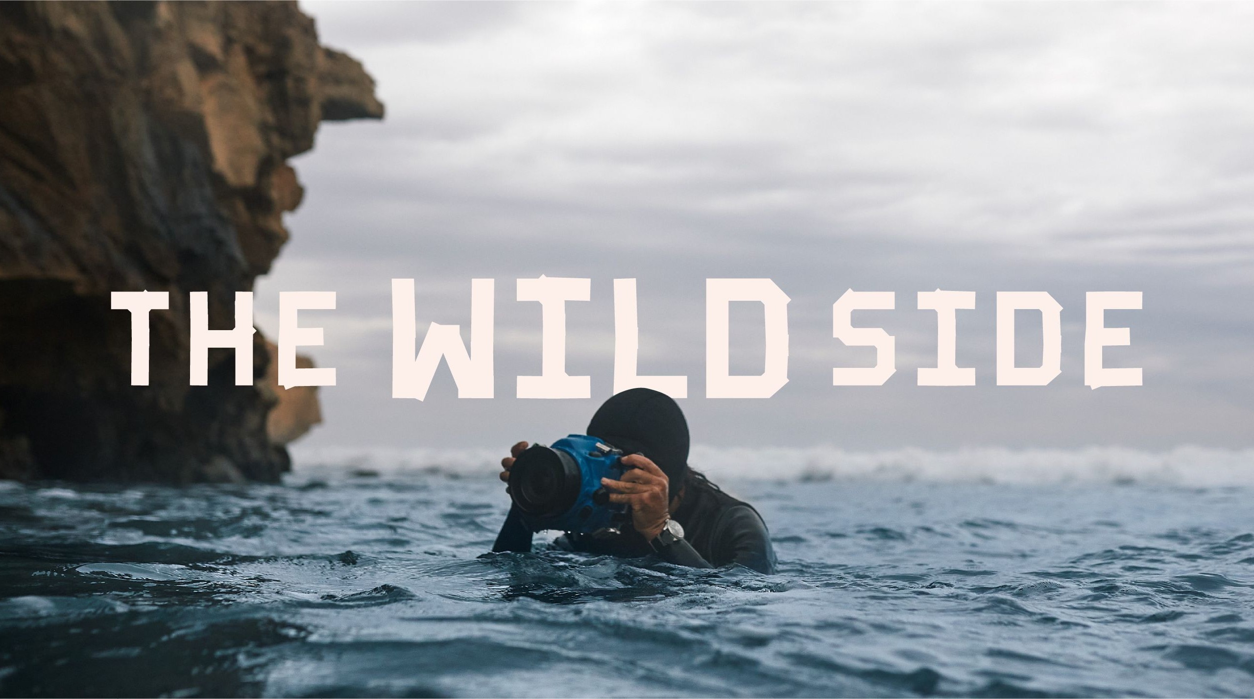 A man filming underwater with the wild side identity