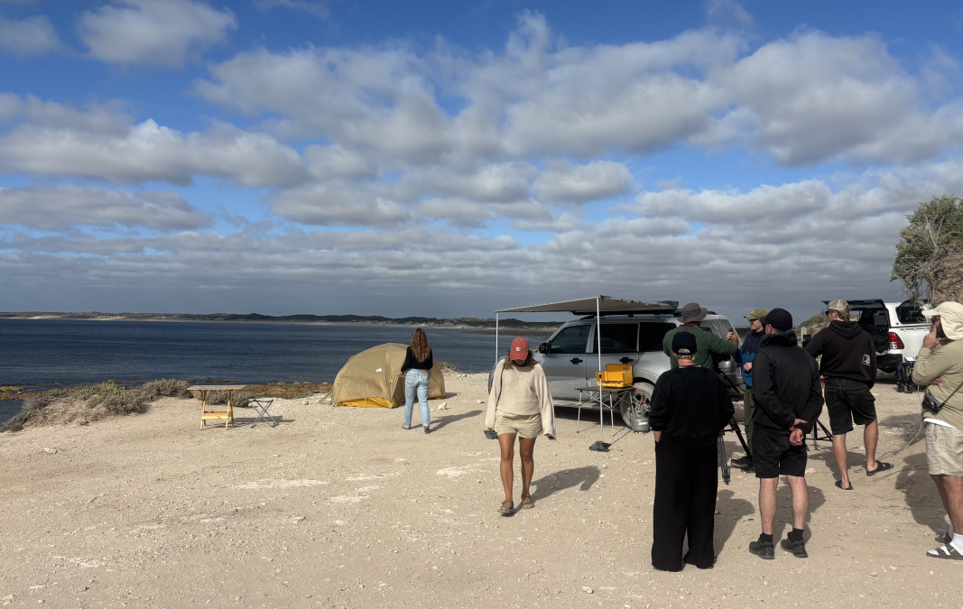 Behind-the-scenes filming of a beachside dining scene for “The Coast is Calling” campaign.