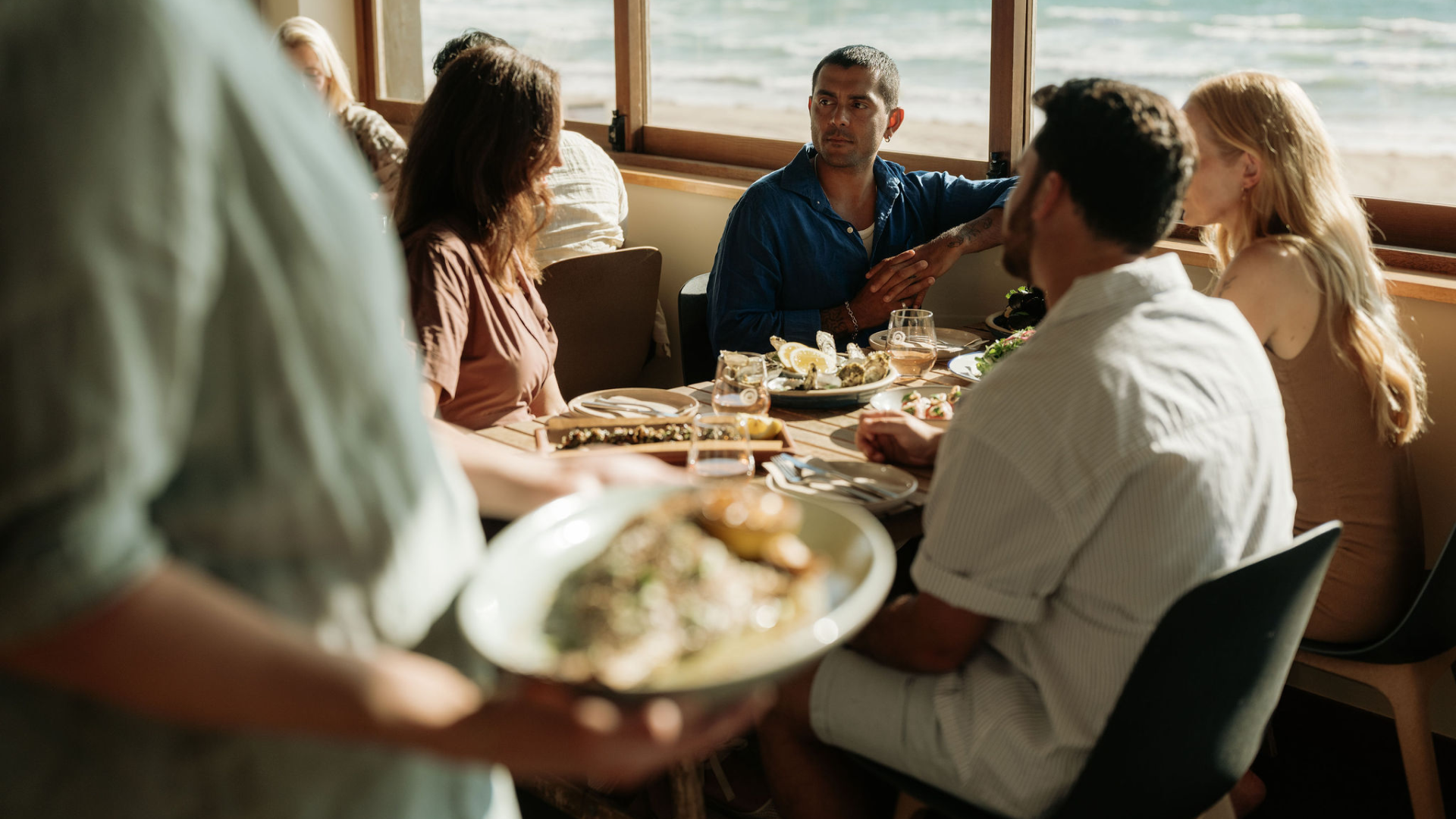 Friends sharing a meal together at a coastal South Australian venue.