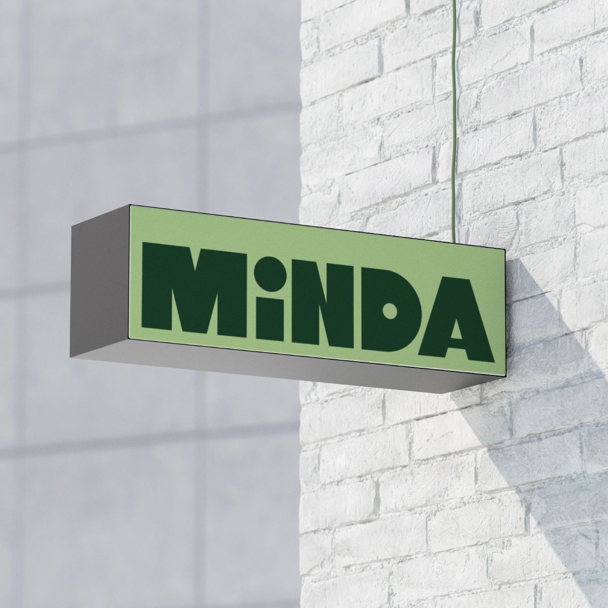 Minda branded building signage featuring the green visual identity.