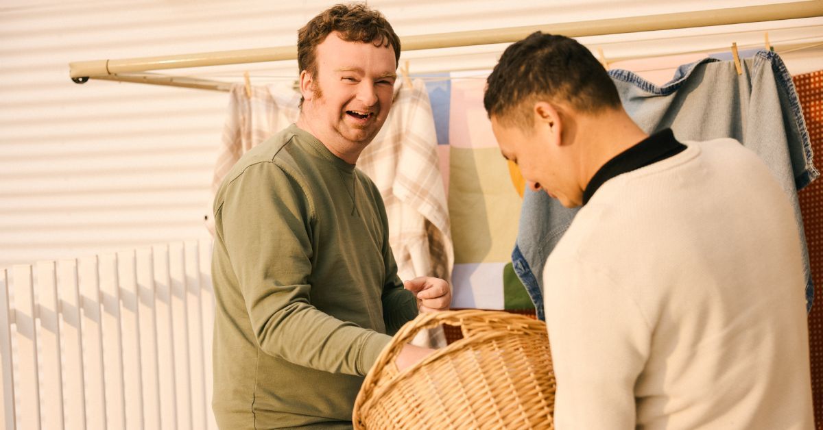 Two people smiling together during a Minda community activity.