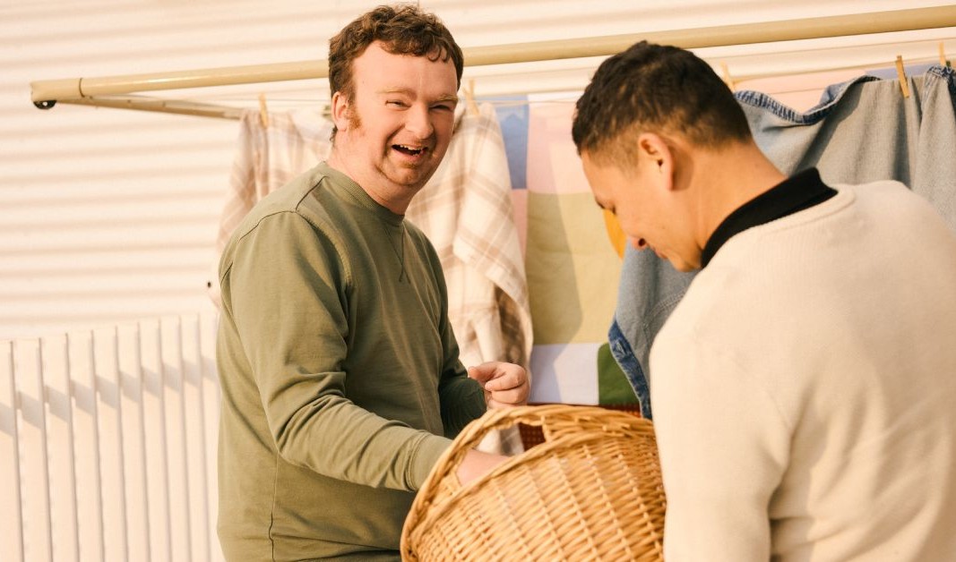 Two people smiling together during a Minda community activity.