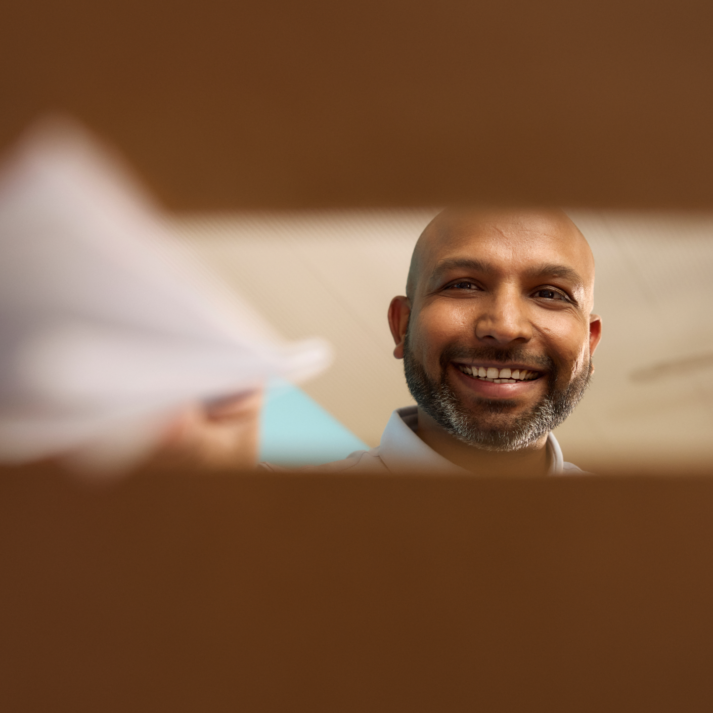 a person placing their vote into a box