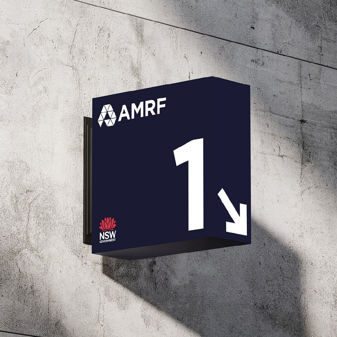 AMRF branded wayfinding sign displaying the number 1 and a directional arrow.