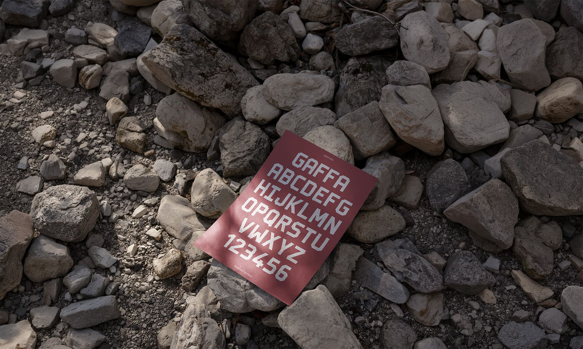 eyre typography shown on a flyer laying on rocks