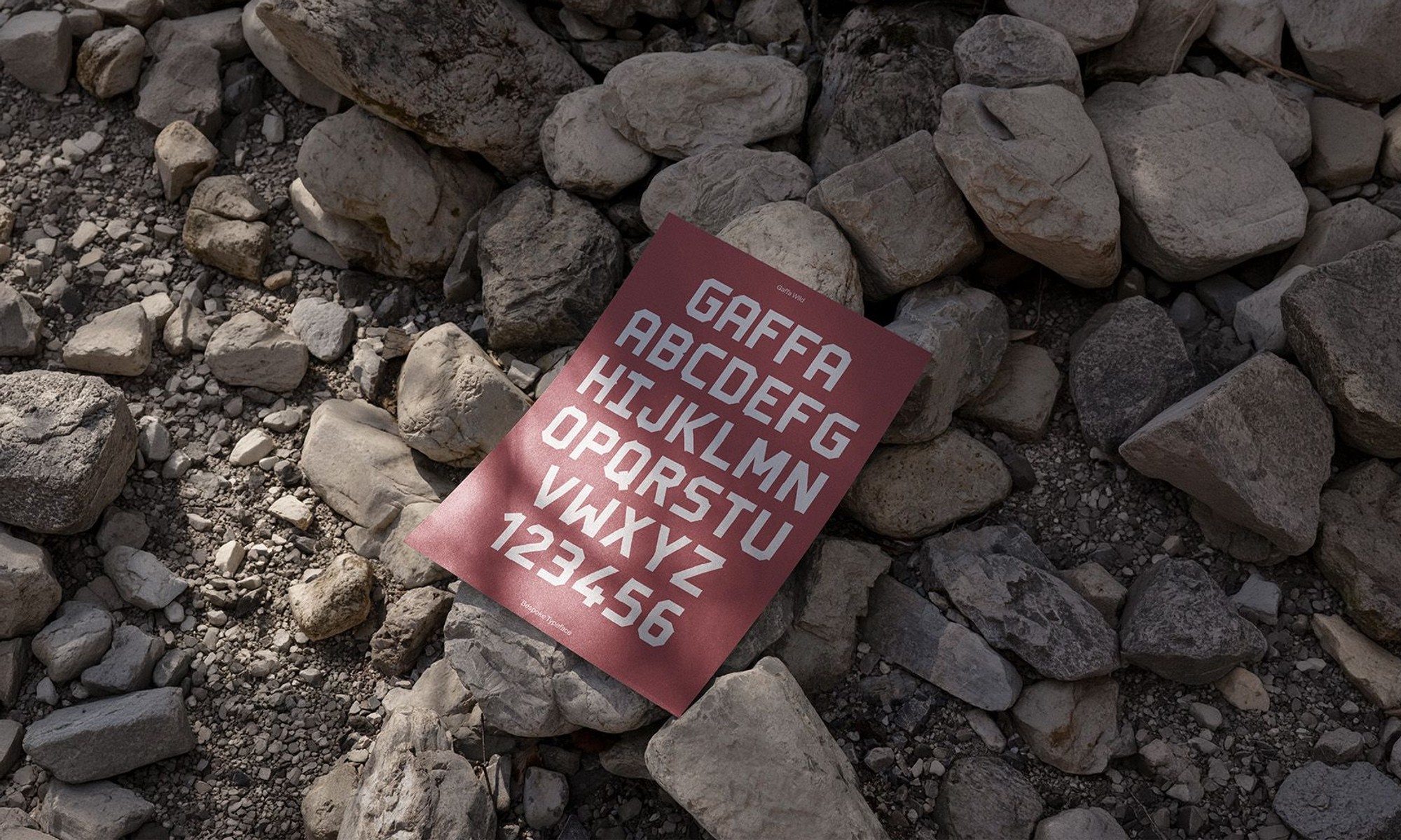 eyre typography shown on a flyer laying on rocks