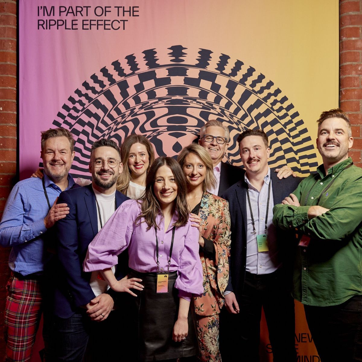 The fuller team in front of the New State of Mind branding