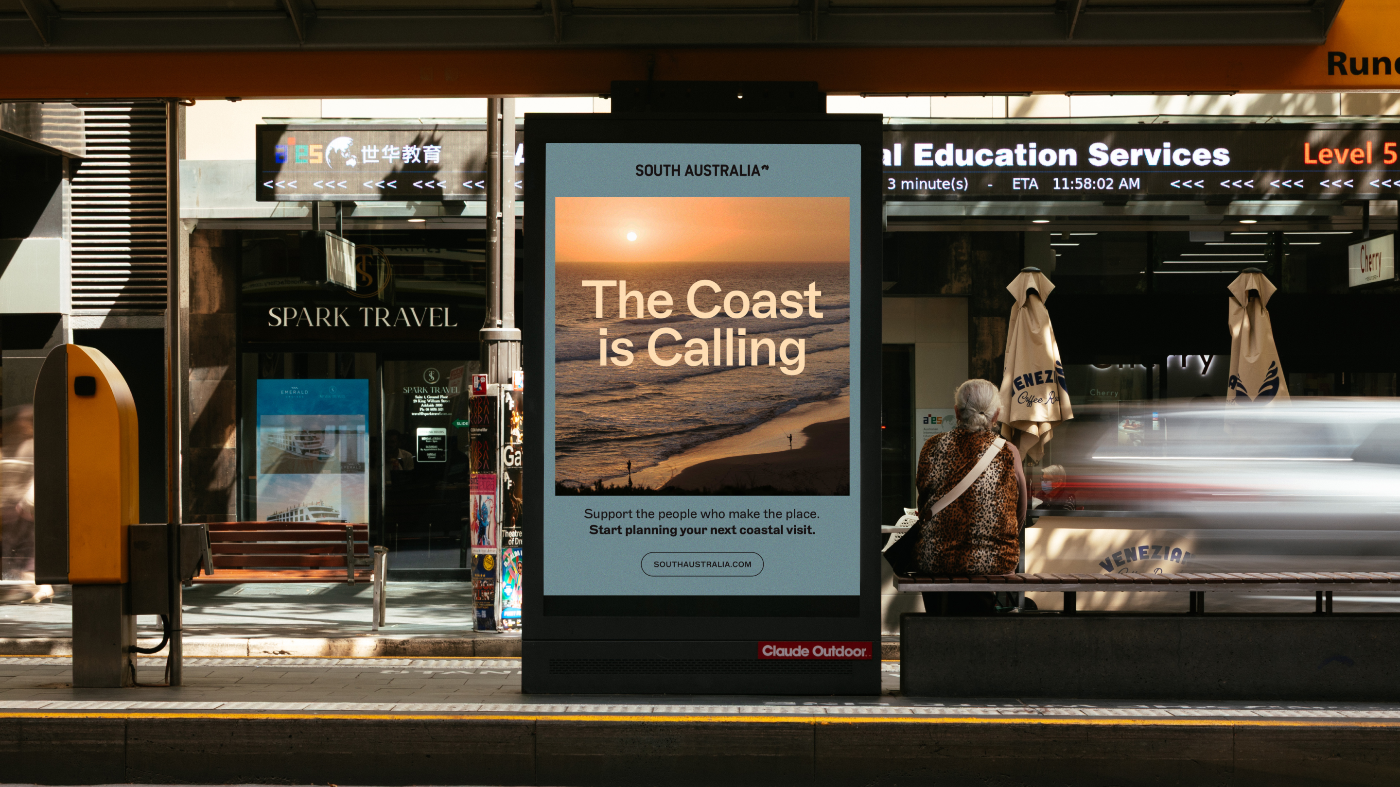“The Coast is Calling” campaign displayed on outdoor advertising at a transport stop.