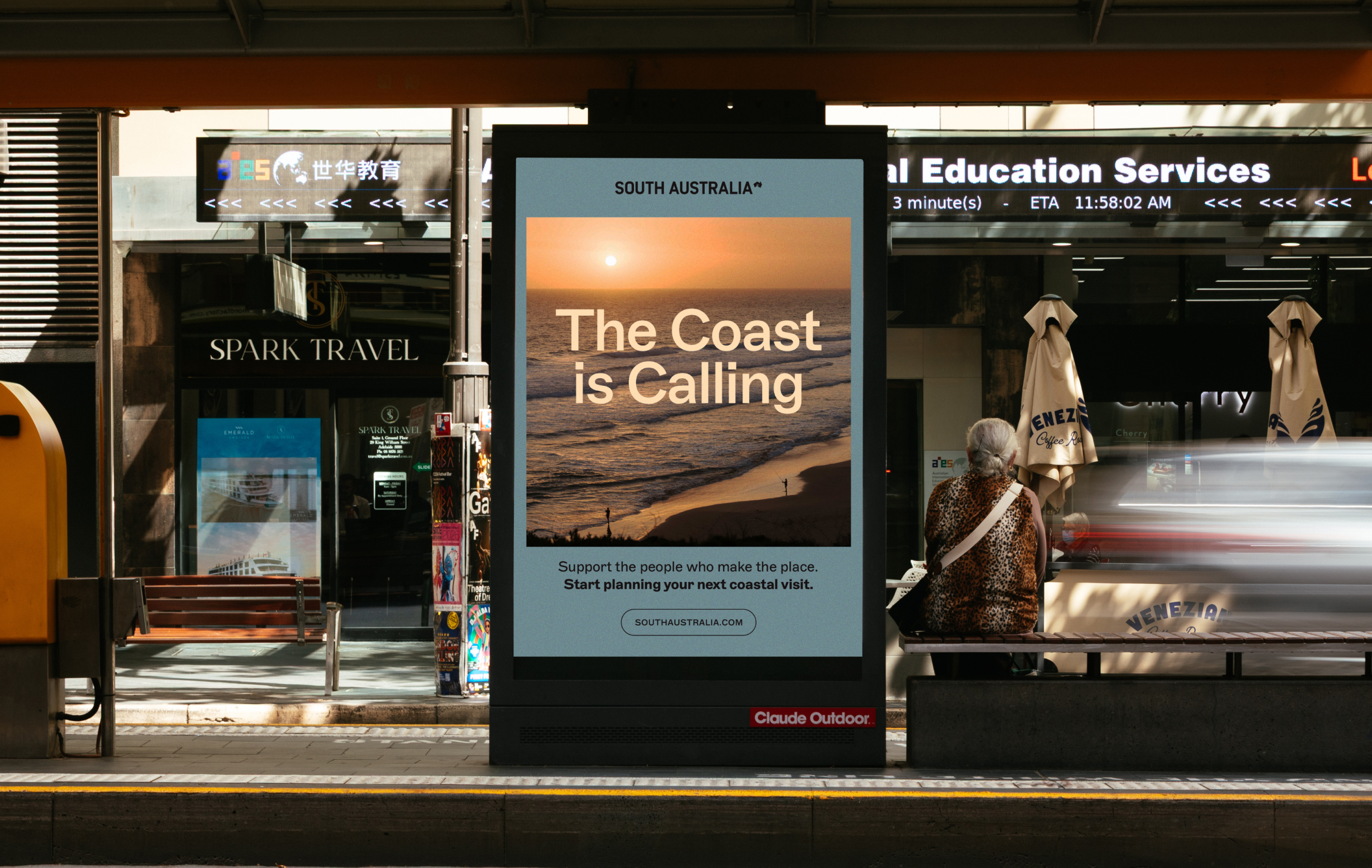 “The Coast is Calling” campaign displayed on outdoor advertising at a transport stop.