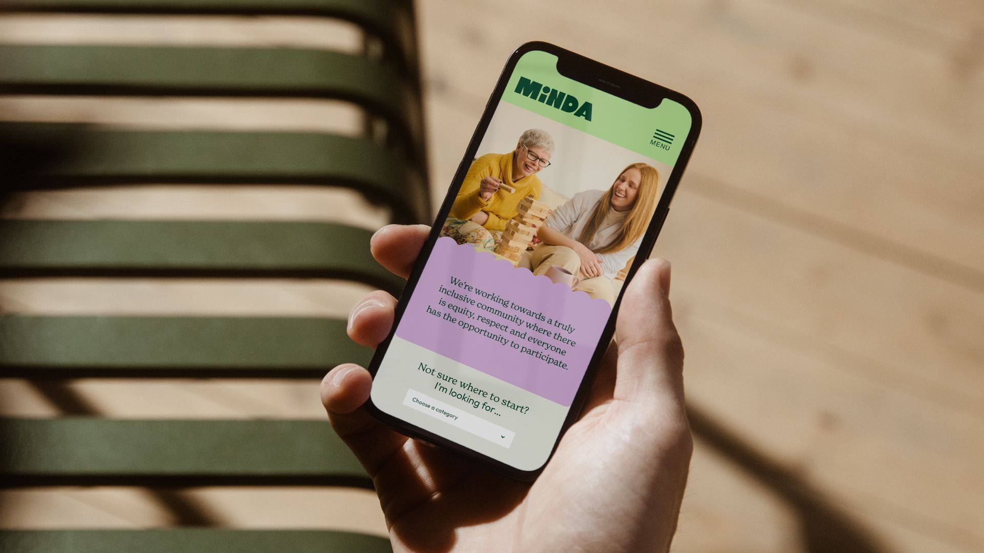 Minda website displayed on a mobile phone.