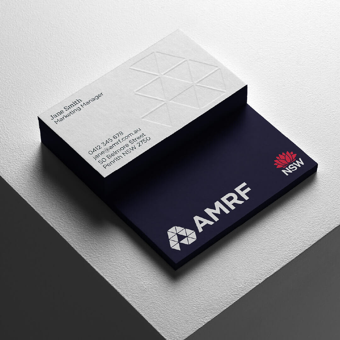 AMRF business card design featuring the navy and white brand identity.