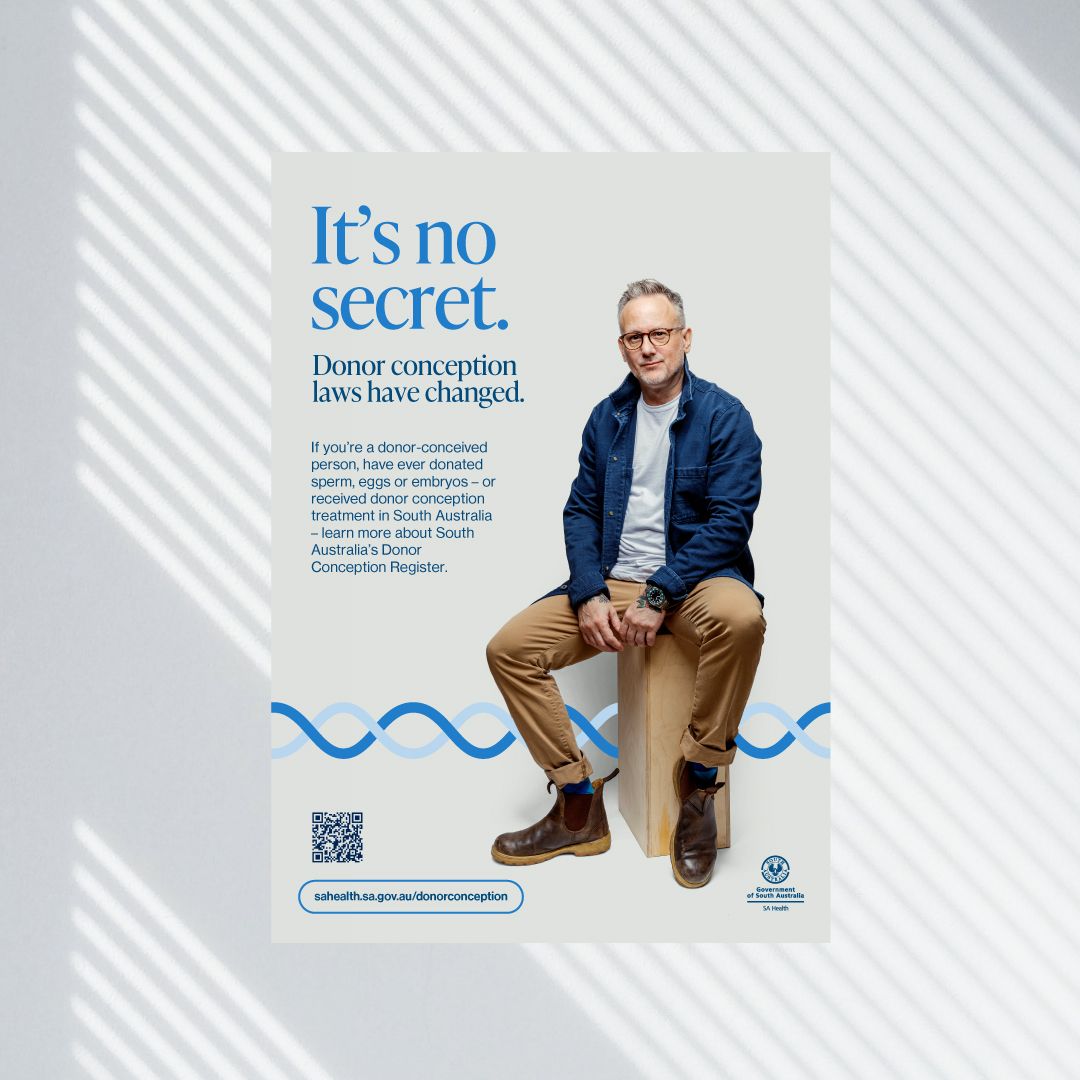A vertical SA Health poster featuring text about changes to donor conception laws alongside a person in glasses, a blue jacket, chinos, and Blundstone boots. Includes a QR code, web link, and SA Health logo at the bottom.