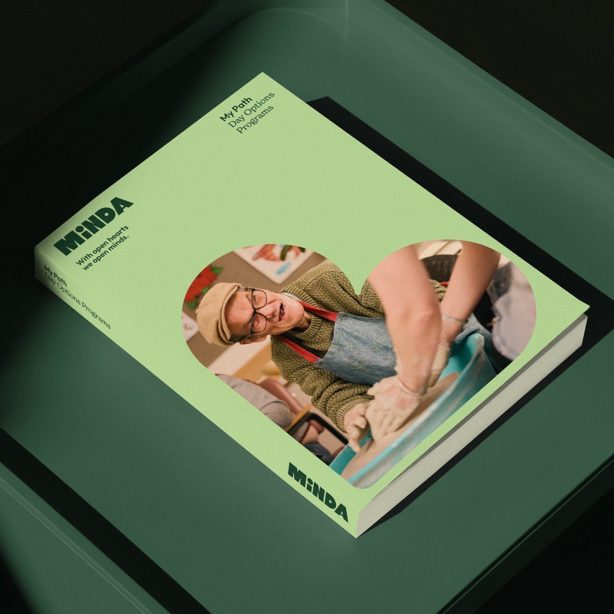 Minda branded publication featuring people participating in community activities.
