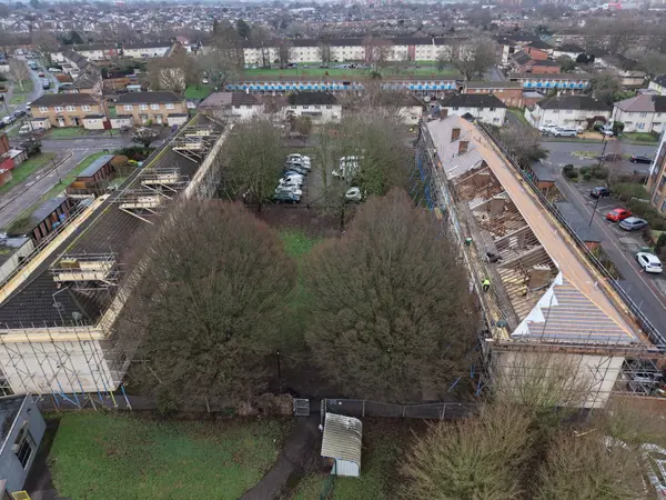 Drone progress photograph showing exposed roof timbers, scaffold access and partial membrane installation at Fernside Close.