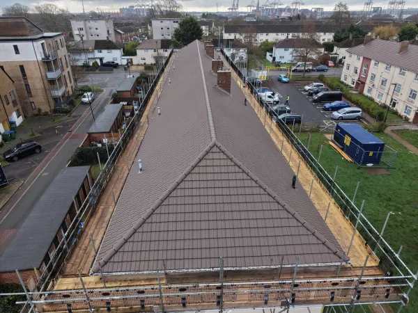 Drone view of the completed tiled roof and scaffold access at Honister Close after pitched roof renewal works.
