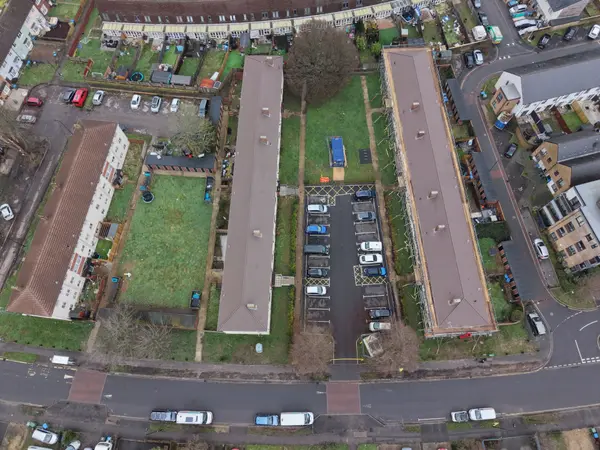Drone view across Honister Close with renewed roof areas and scaffold access visible among the residential blocks.