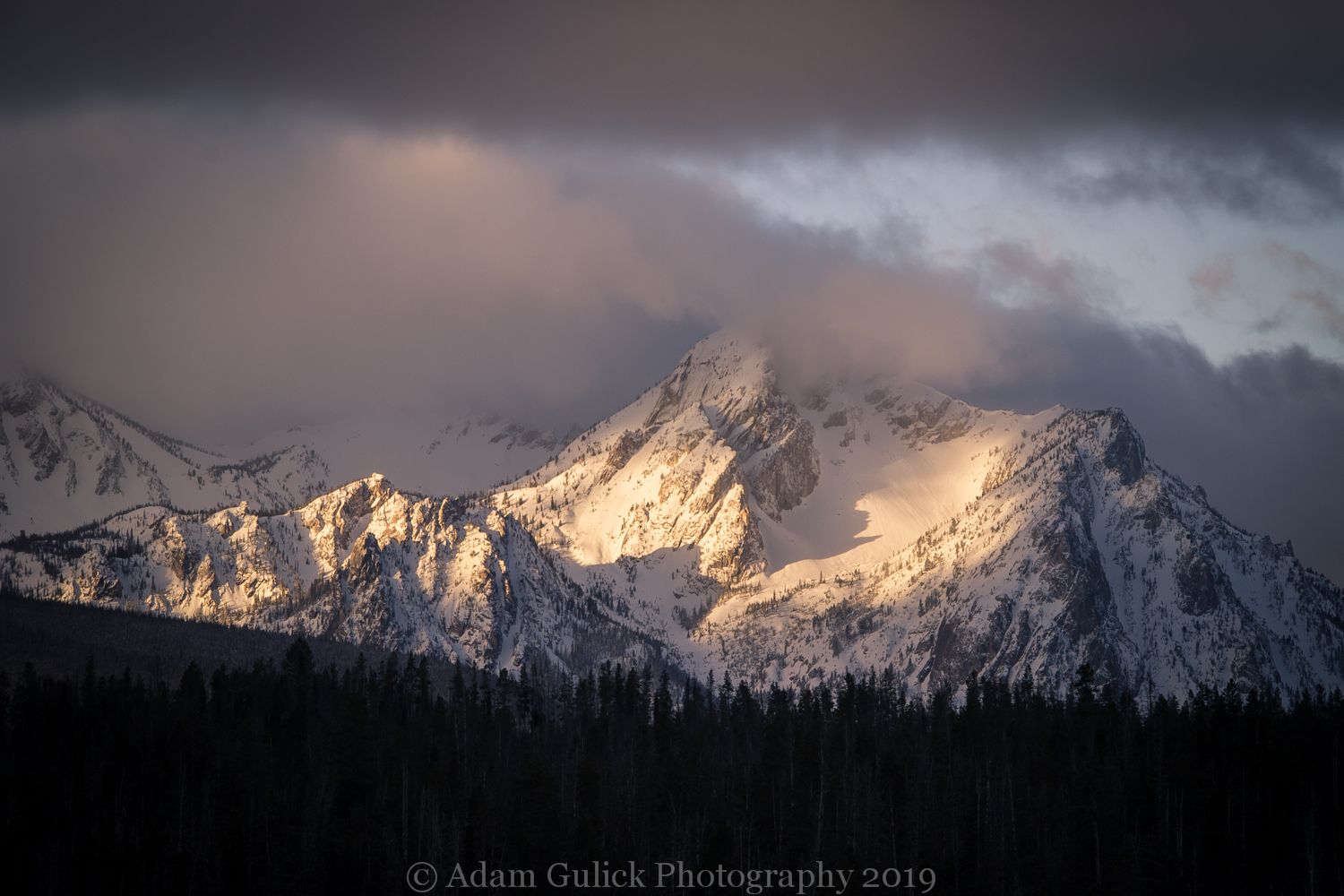 Clouds coming over a snowy mountain Stanley, ID | Stanley Chambers