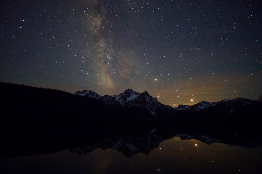 stars at night over mountains and reflecting in lake | Stanley chamber