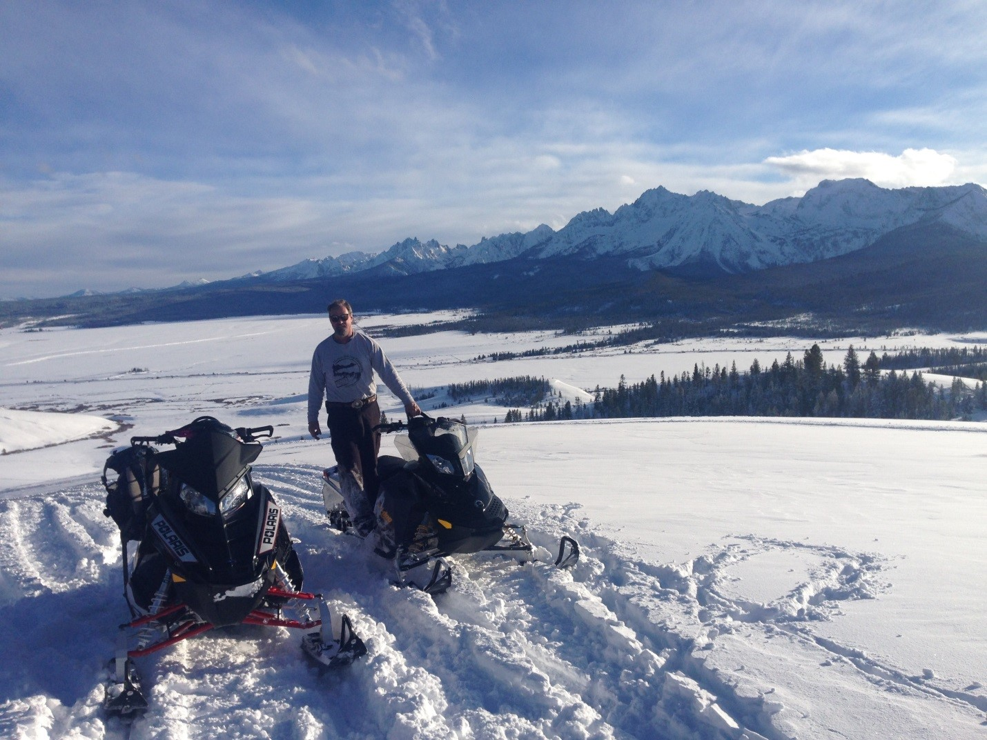 snowmobiles with mountains in background | Stanley chamber