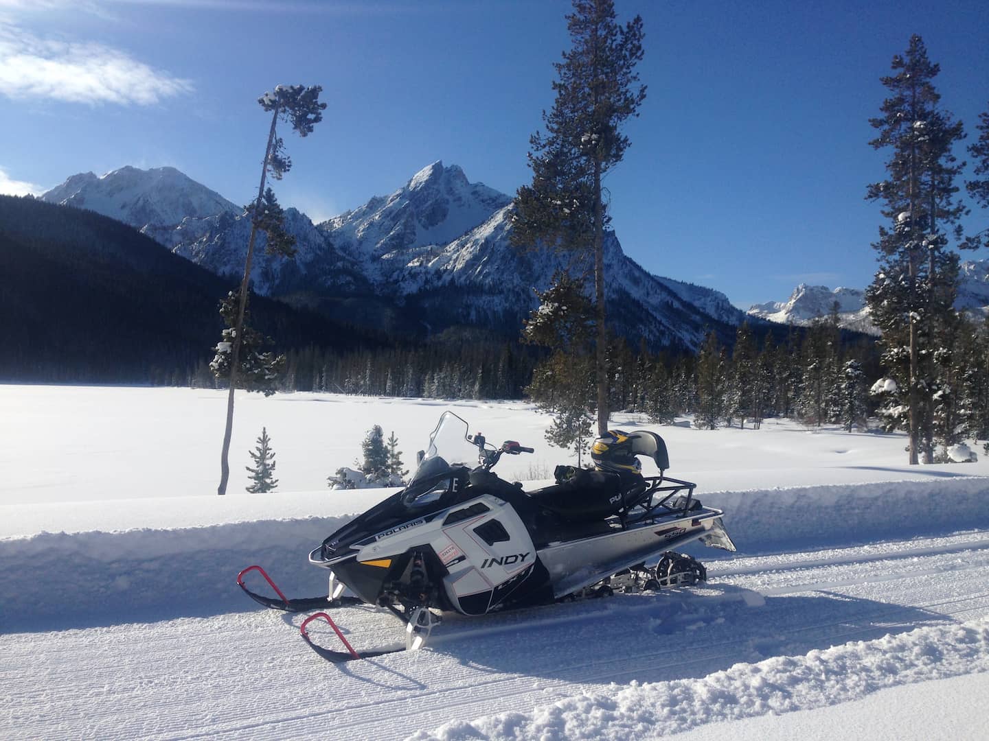 Snowmobile on a road in front of a mountain