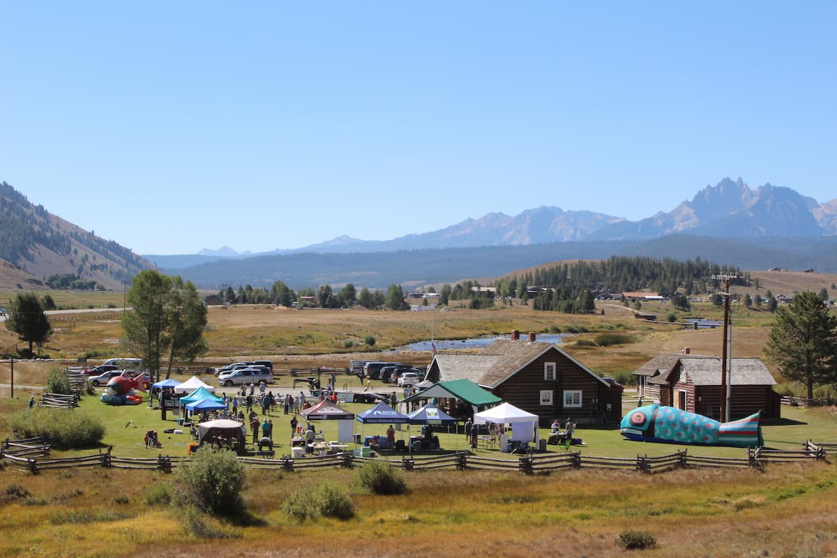A photograph of the Salmon Festival along a mountainous landscape