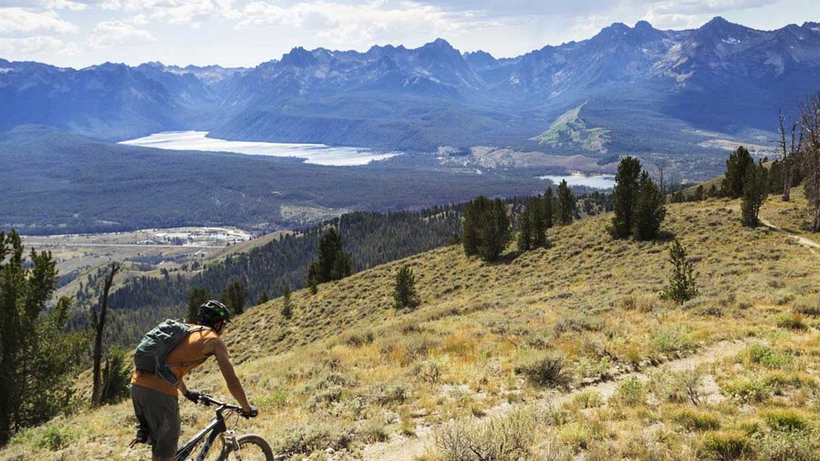 A mountain biker going down a mountain in Stanley, ID | Stanley Chamber
