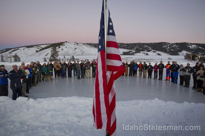 Skaters on the ice looking at an American flag | Stanley Chamber