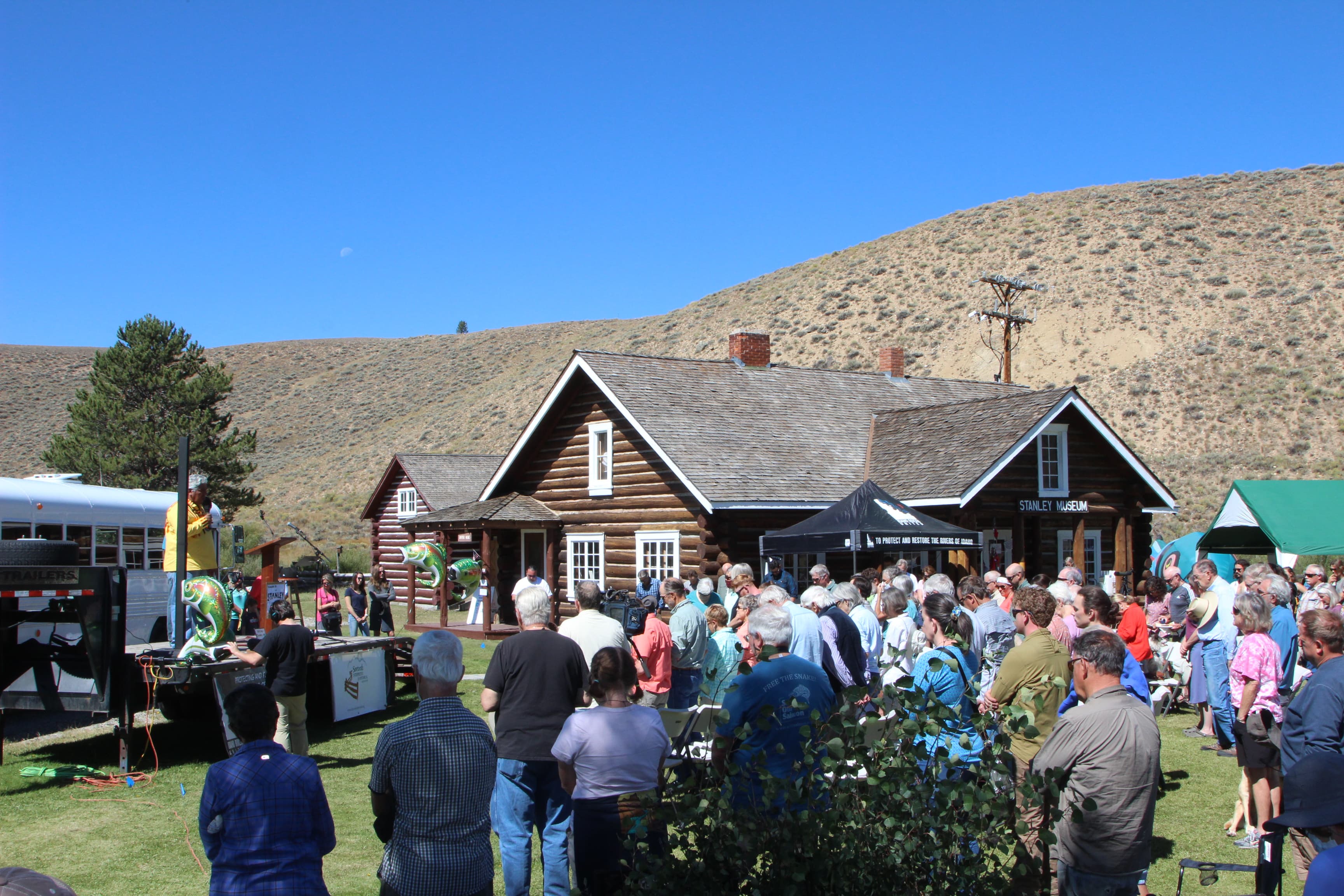 A crowd gathered in front of a cabin at the Stanley Salmon Festival