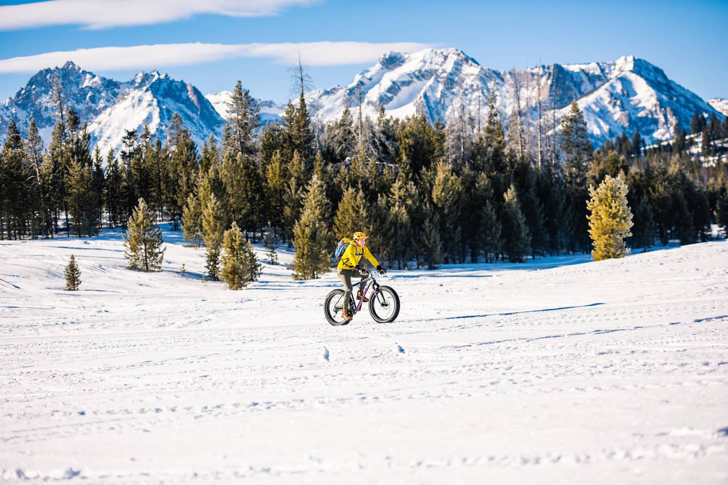 A biker riding along the snowy Stanley landscape