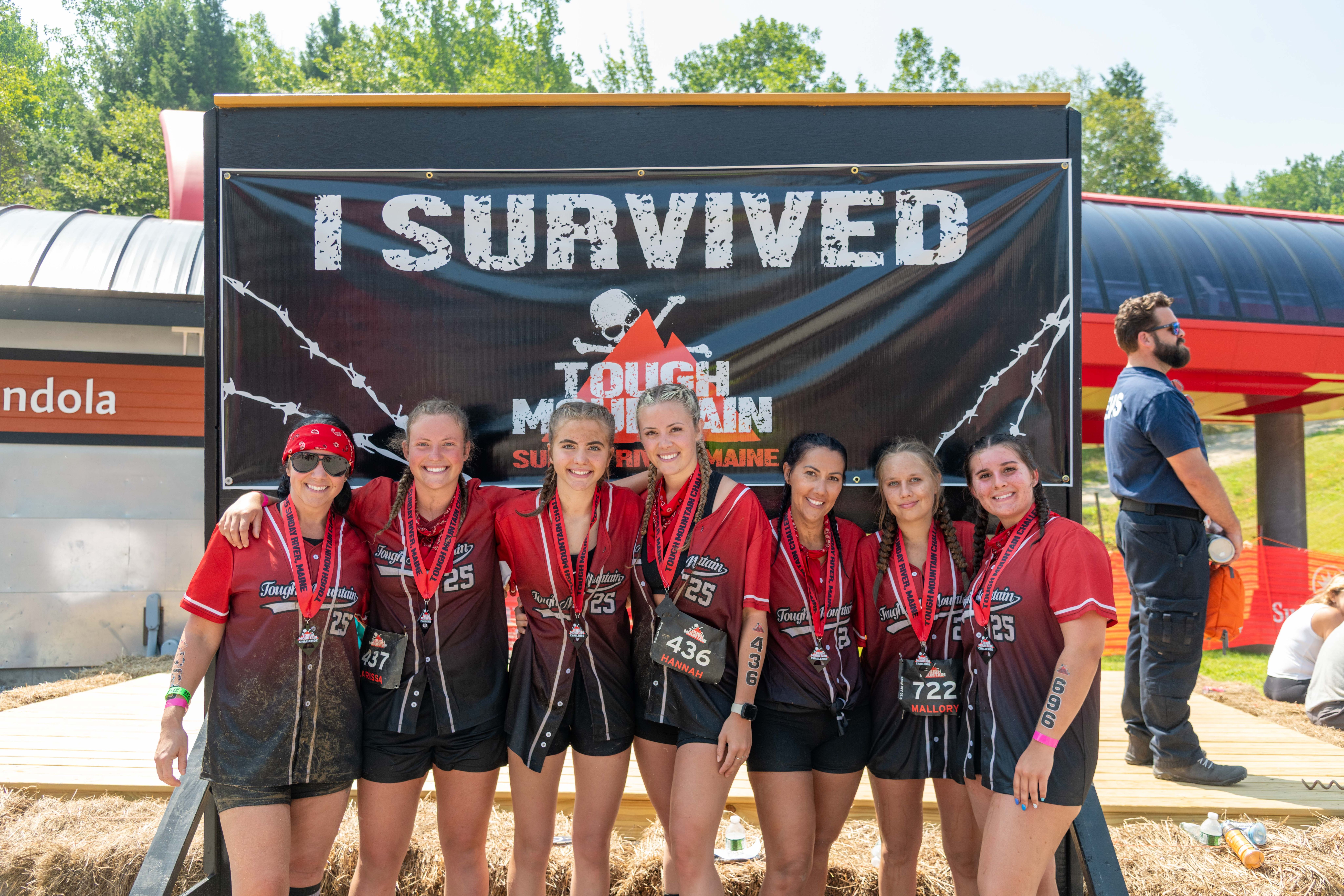 People posing for a group picture after completing the Tough Mountain Challenge.