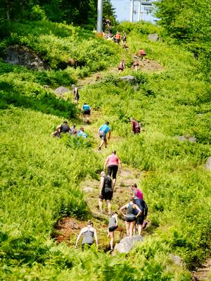 Competitors running uphill at Sunday River's Tough Mountain Challenge.