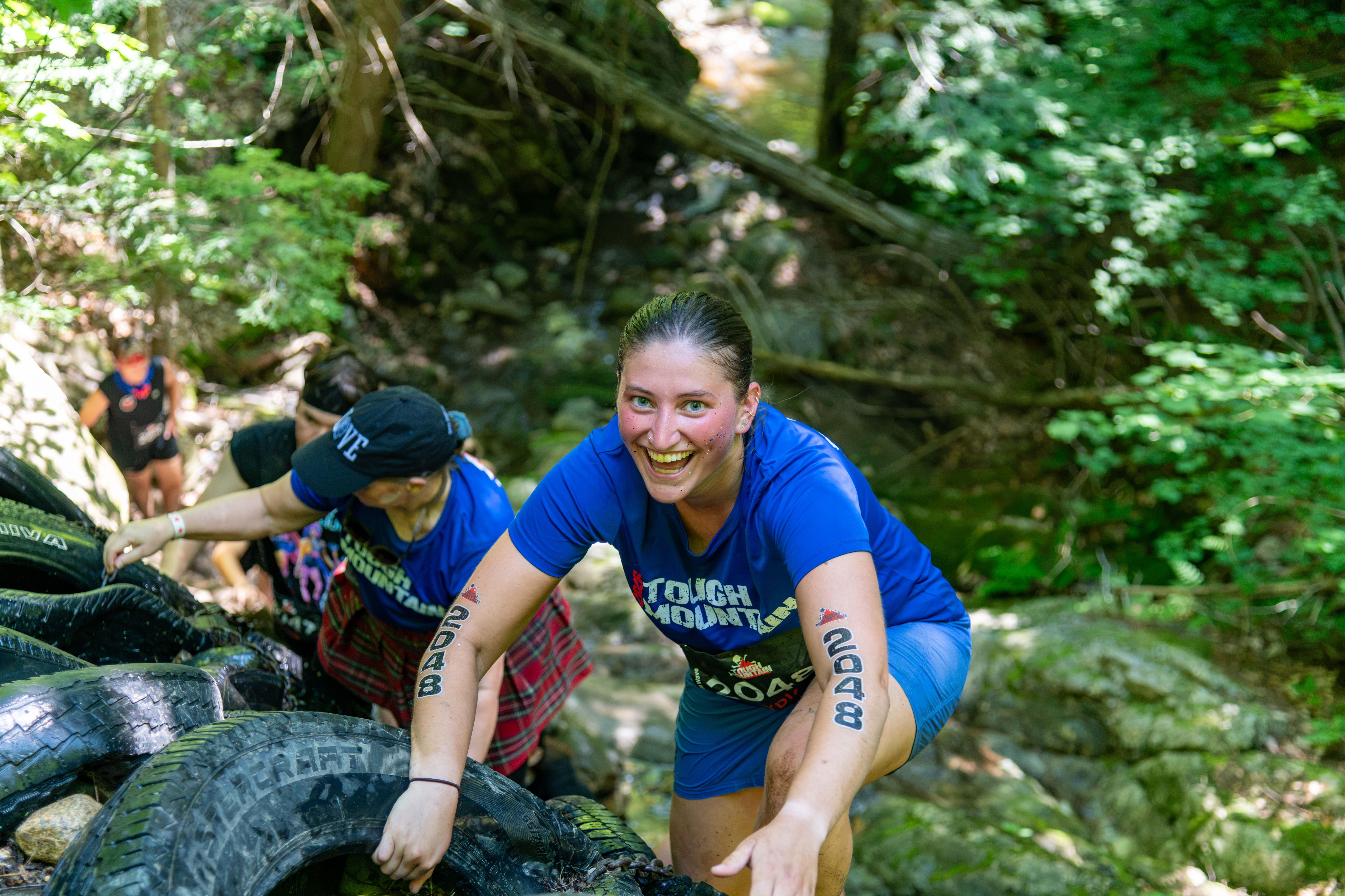Race competitors crawling through the tire wall at Tough Mountain Challenge.