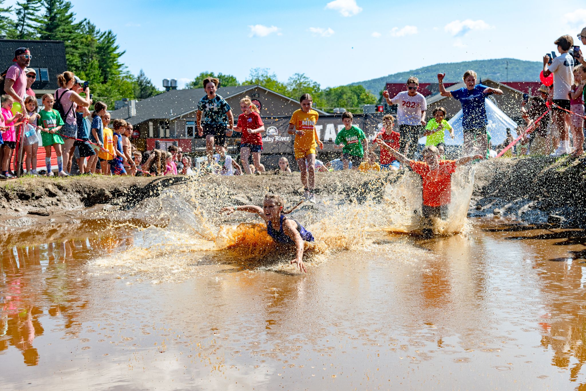 Mini Mountain runners crashing into the muddy water.