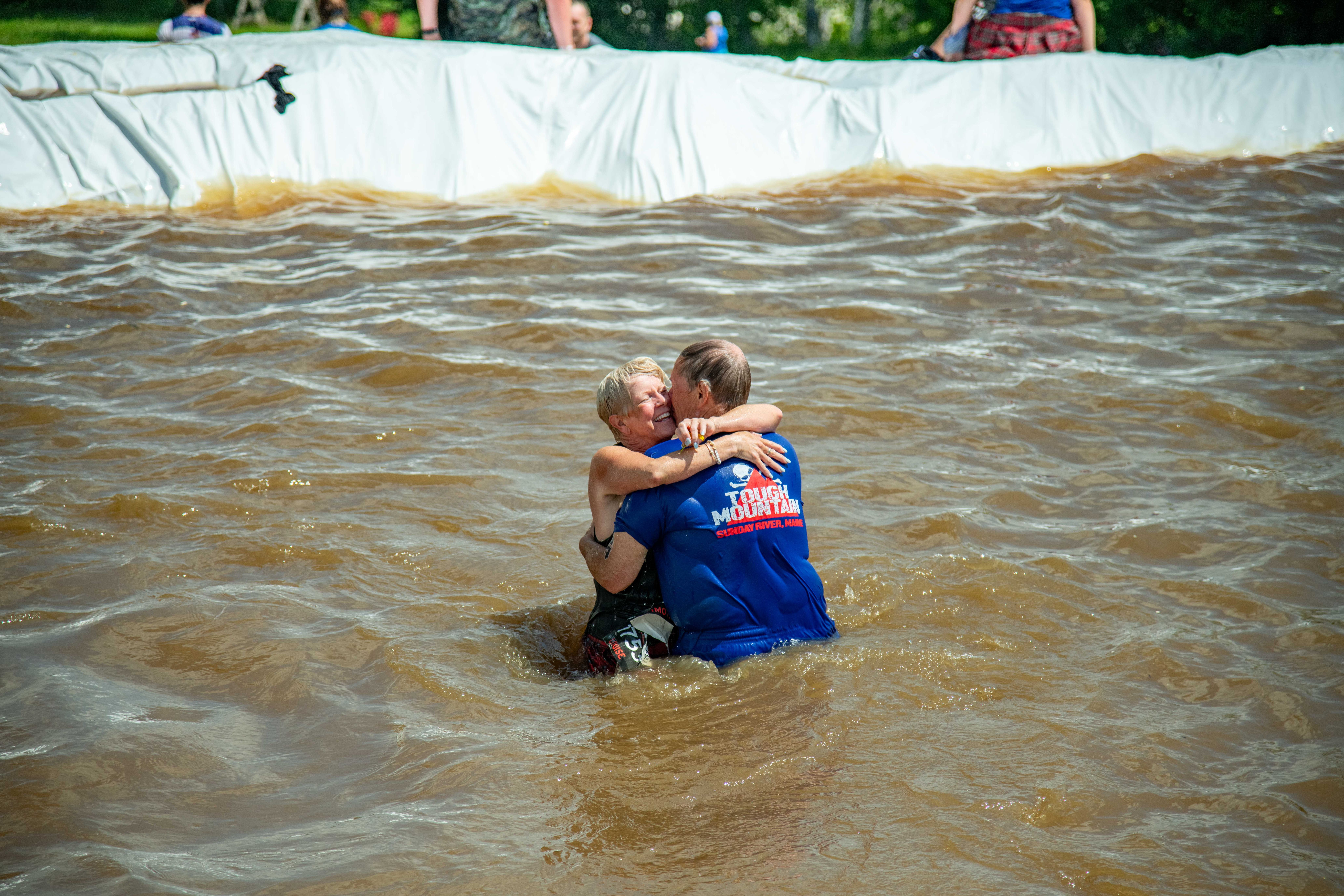 People hugging in the water.