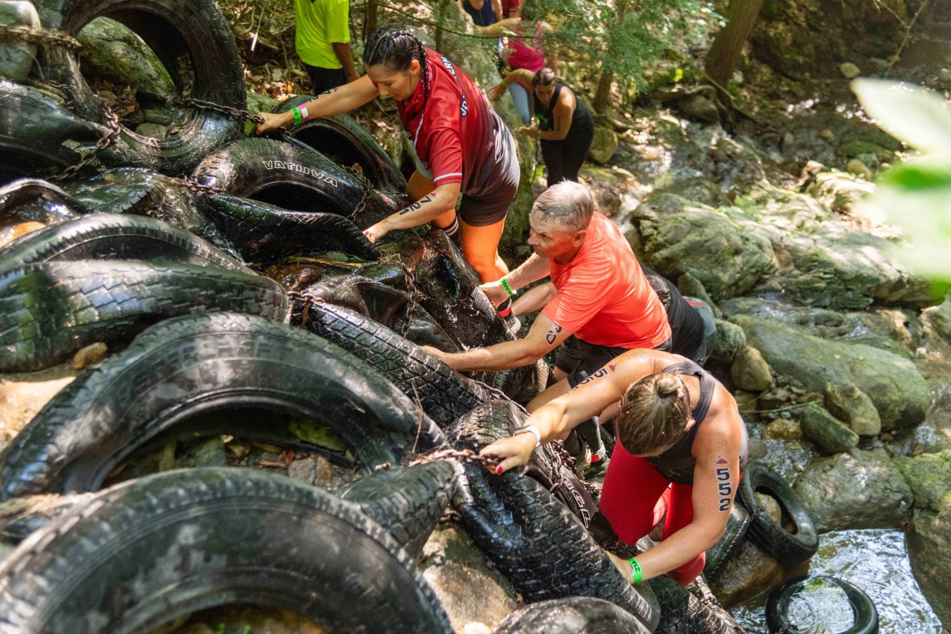 A group of women finishing the tire wall at Tough Mountain Challenge.