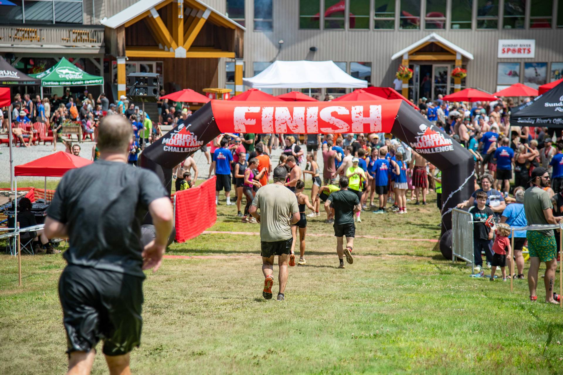 People crossing the finish line at the Tough Mountain Challenge.