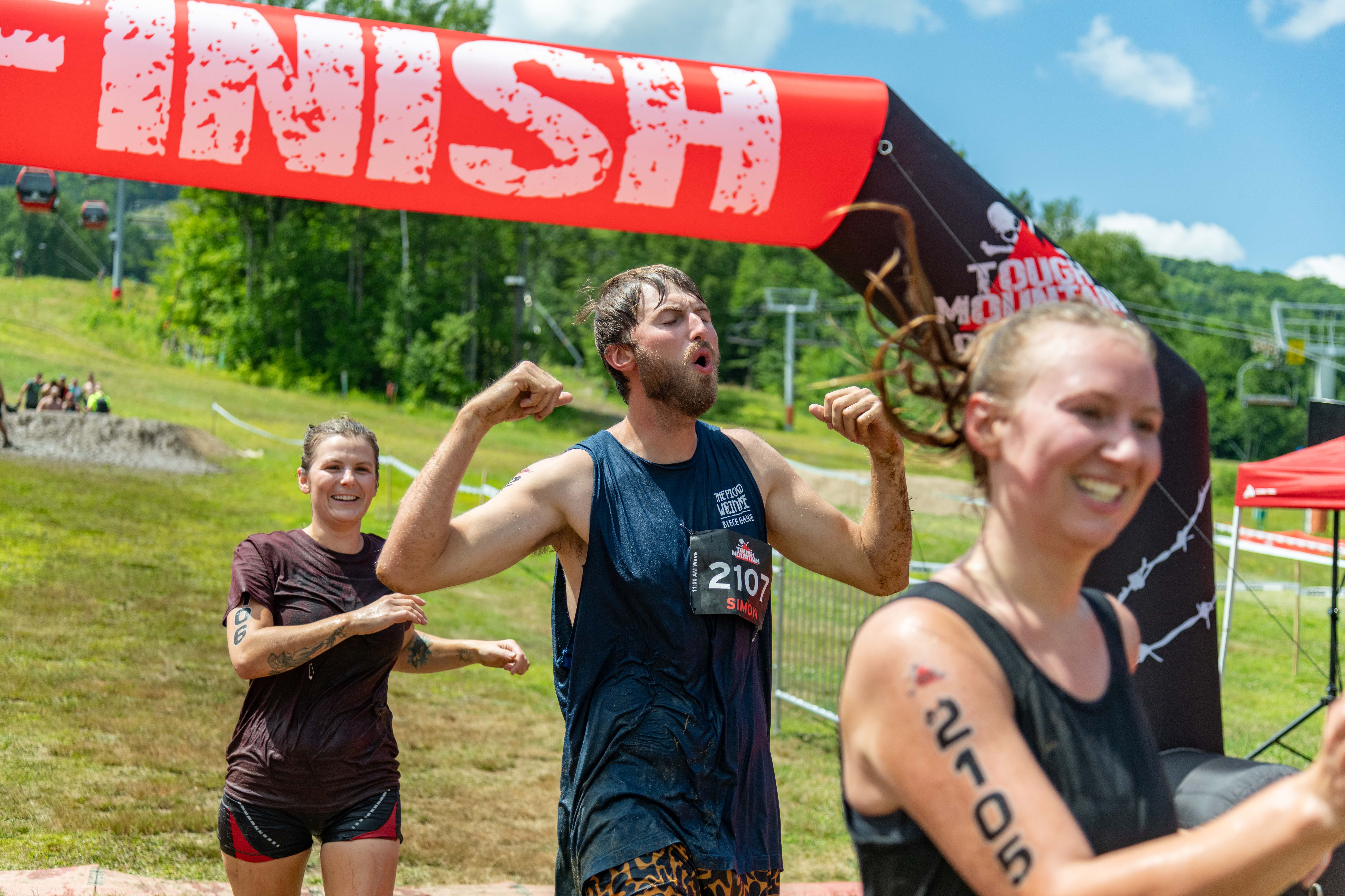 People crossing the finish line triumphantly at Tough Mountain Challenge.