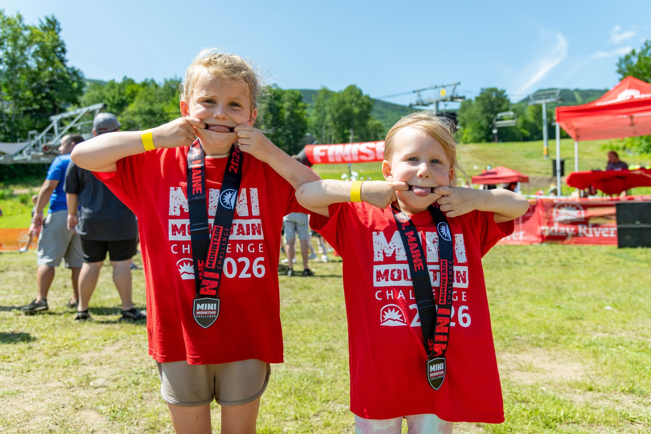 Two racers holding their medals after the Mini Mountain Challenge.