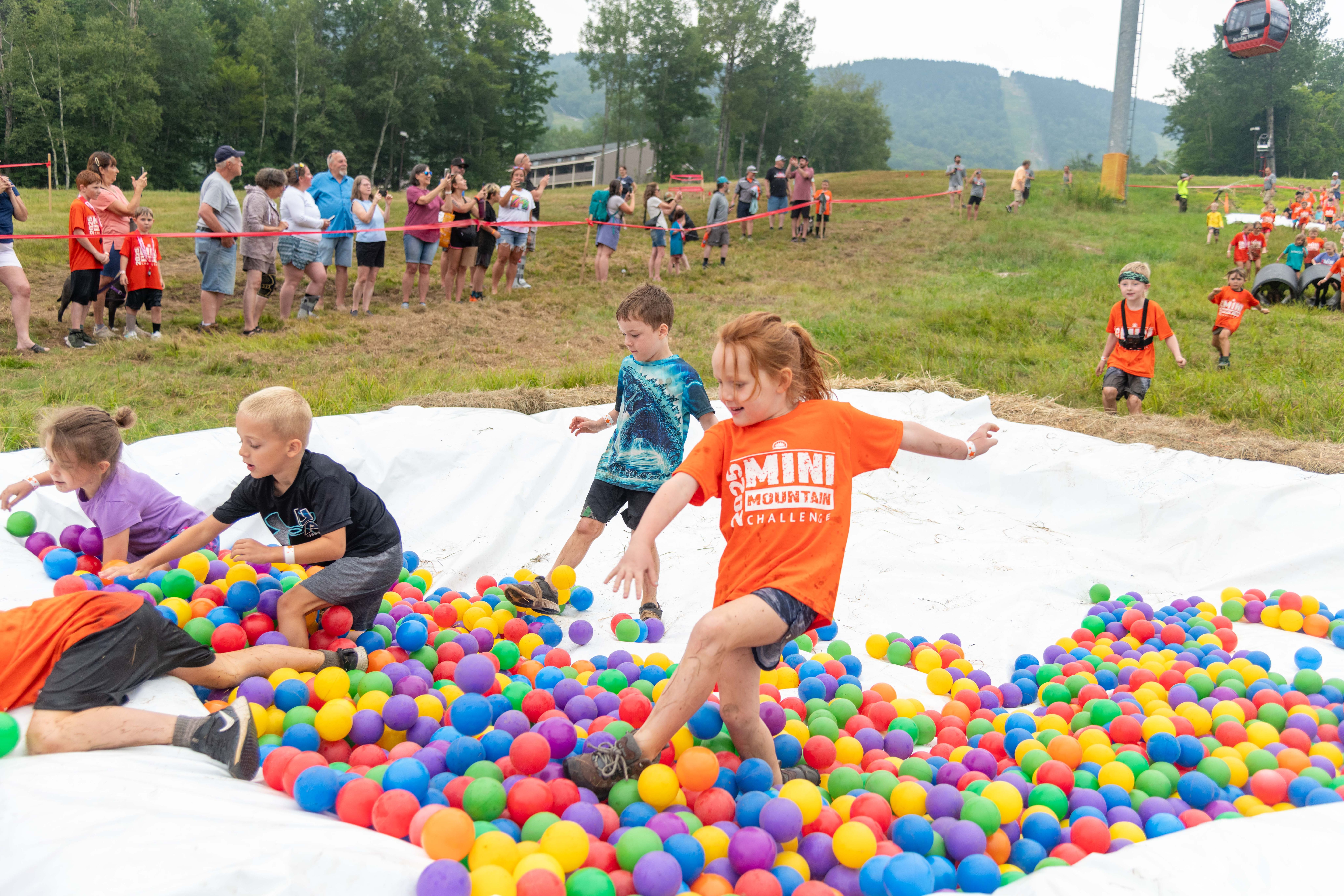 Mini Mountain racers walking through the ball pit.